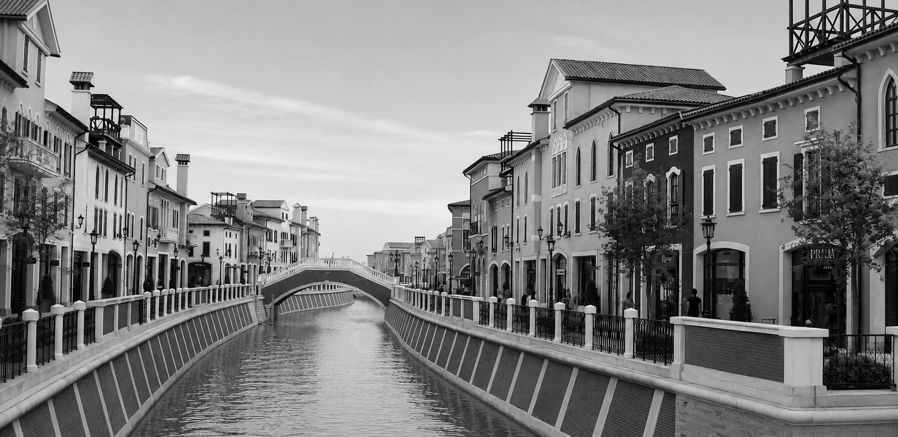 Black and white canal district with bridge